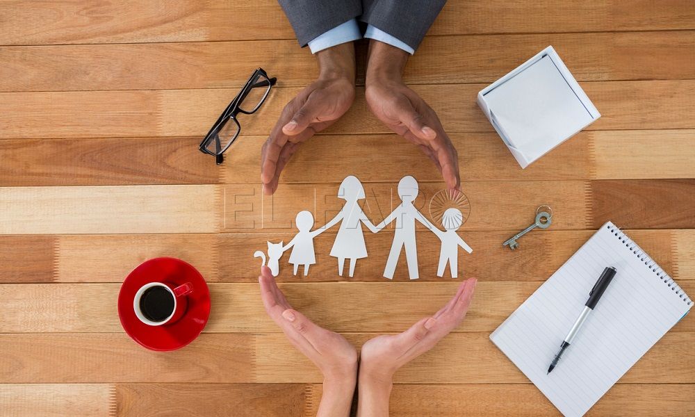 Cutout paper chain family with the protection of hands on table
