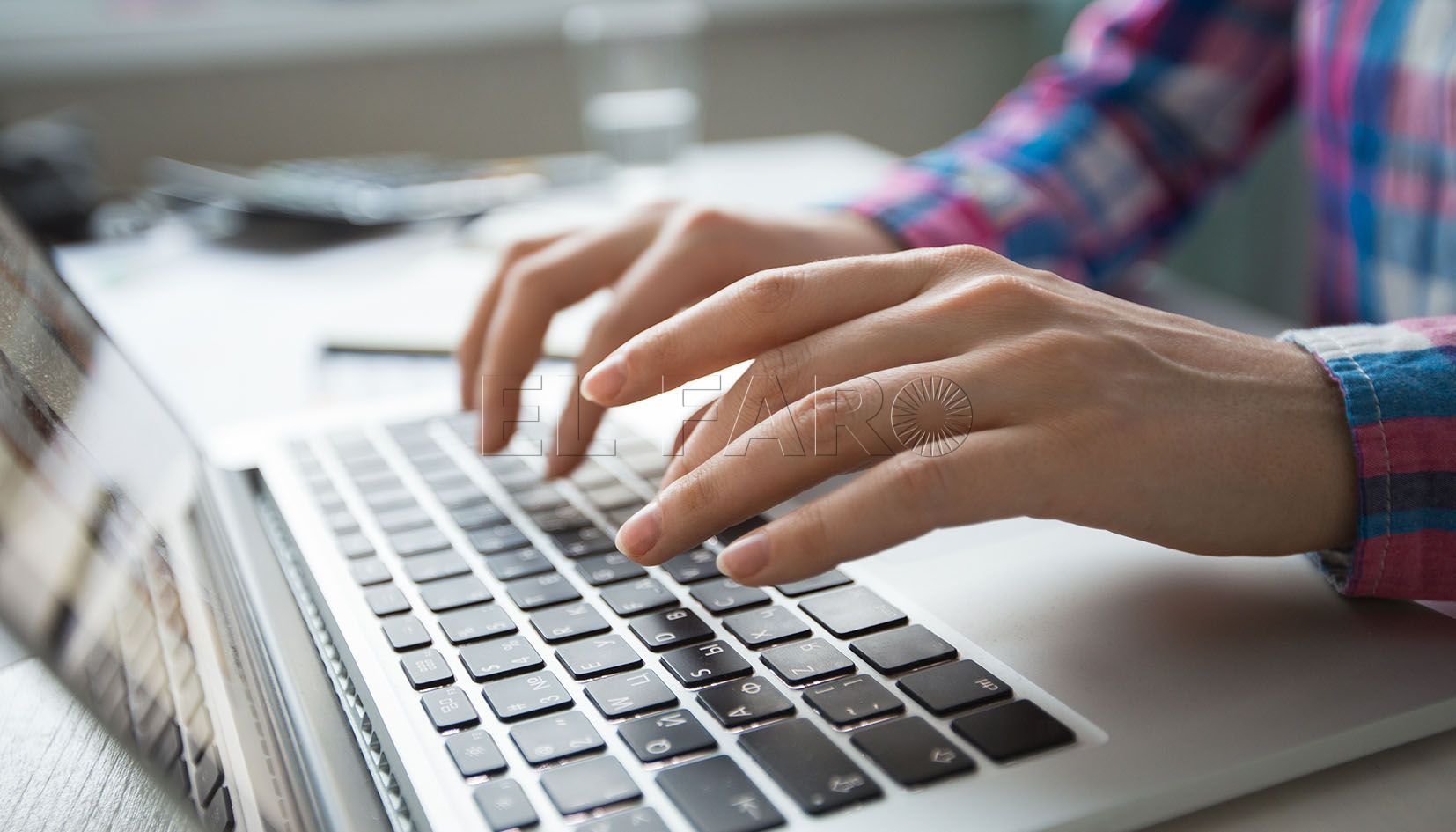Cropped view of person hands typing on laptop computer