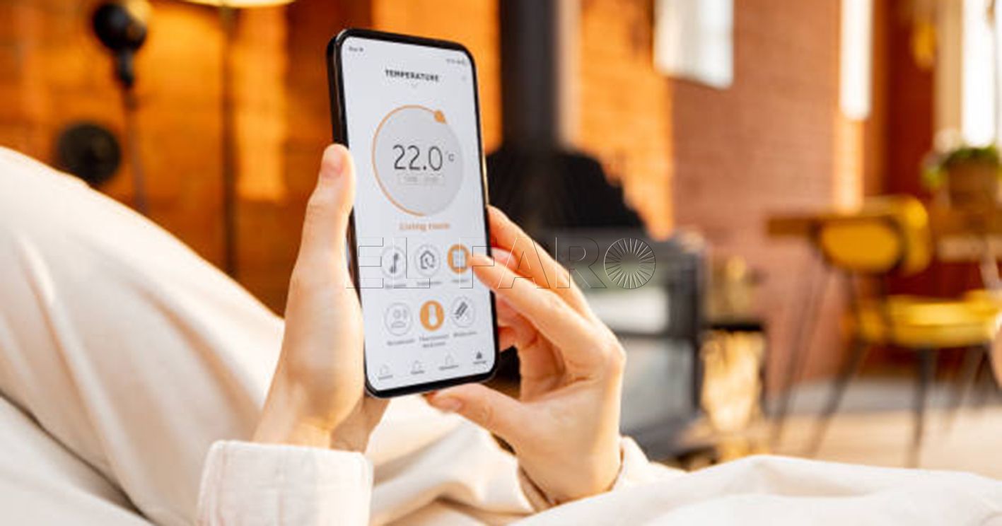 Woman holding phone with running smart home application for heating temperature control, while lying relaxed at home. Close-up on device screen